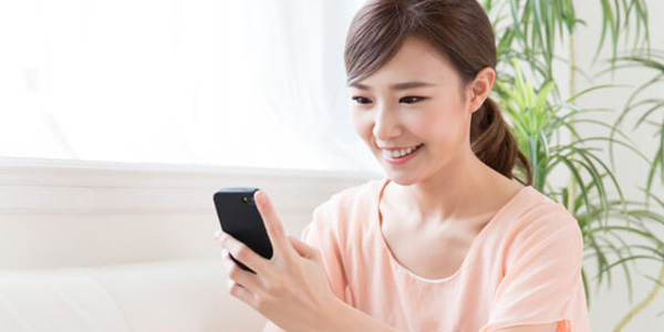 スマートフォンで申し込む女性